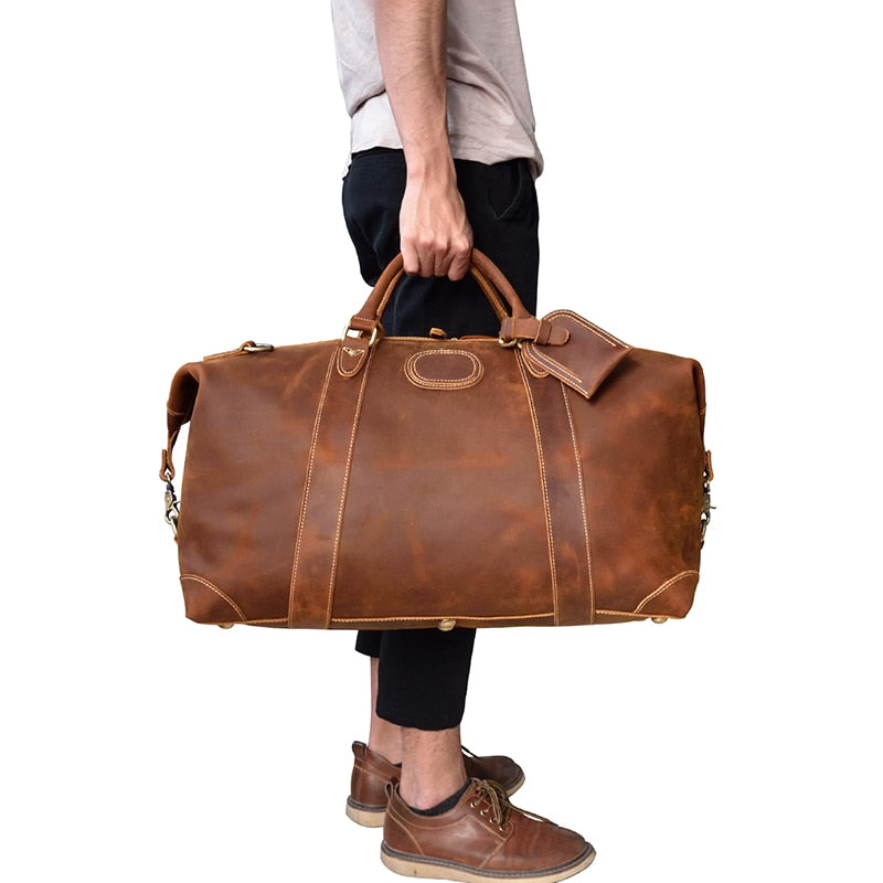 Vintage leather duffle bag made from high-quality crazy horse leather with spacious compartments and adjustable strap.