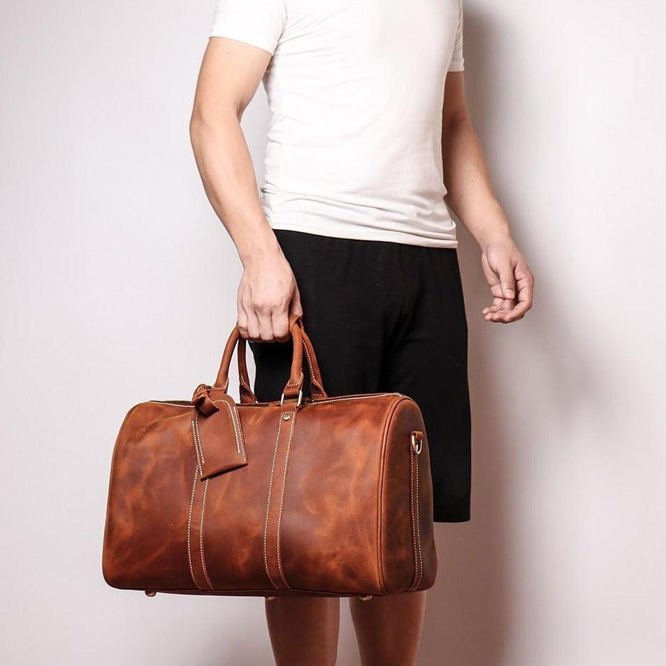 The Brandt Weekender small black leather duffle bag with adjustable shoulder strap and sturdy handles