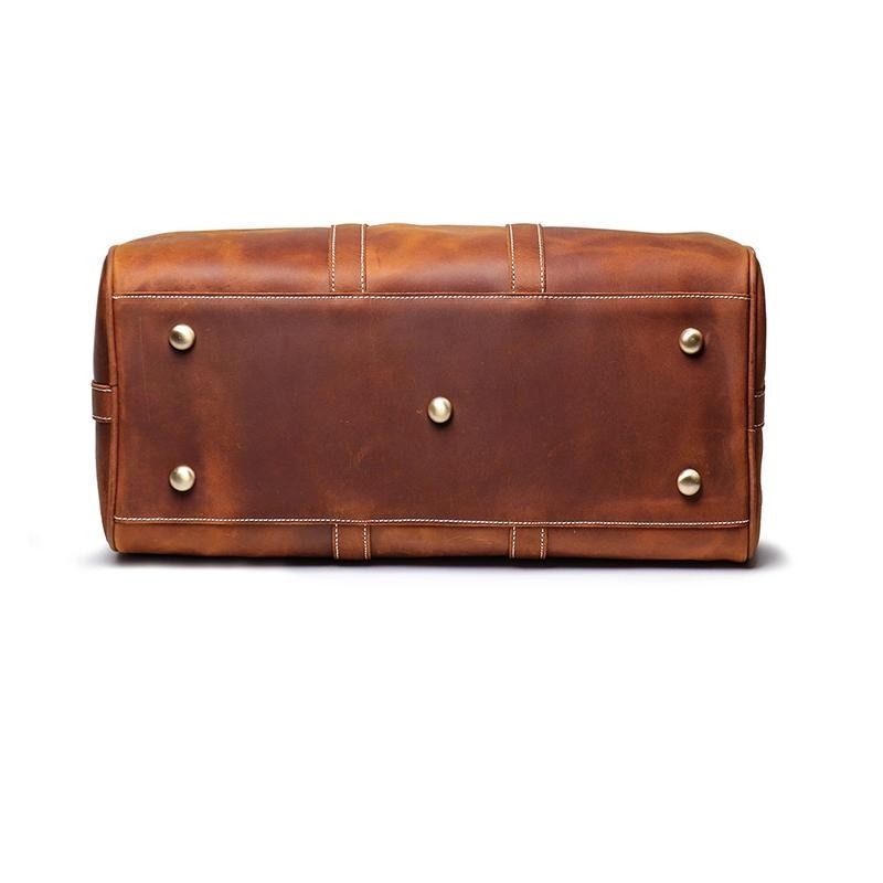 The Brandt Weekender small black leather duffle bag with dual handles and shoulder strap for stylish travel