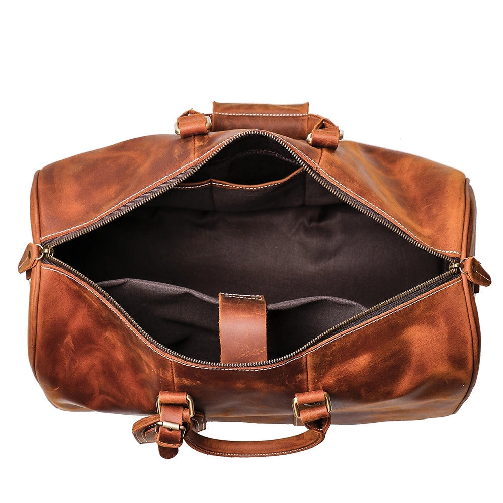The Brandt Weekender small black leather duffle bag with detachable shoulder strap and top handle