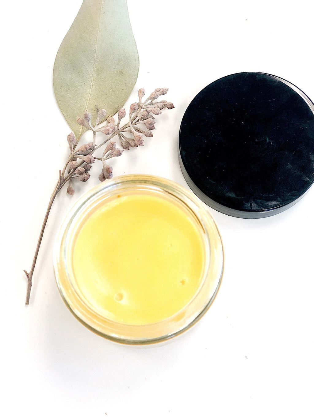 Sea Buckthorn Facial Moisturizer in glass jar with organic ingredients and orange-red hue