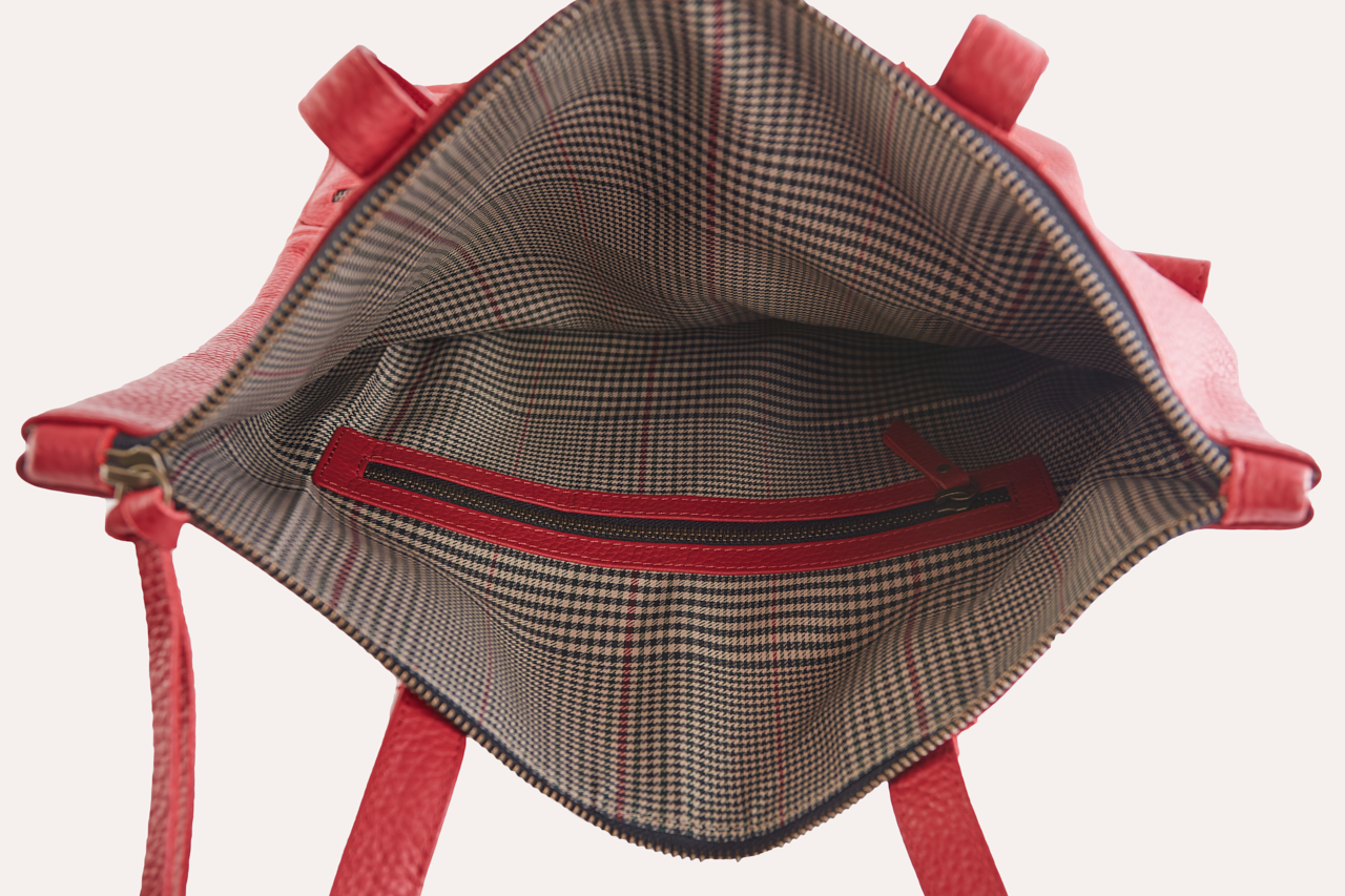 Fold n Hold Tote in cowhide leather with large interior and two exterior pockets, soft supple material, and plaid lining