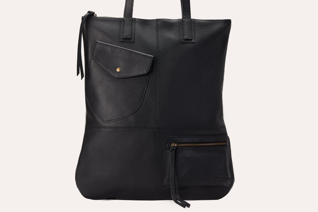 Fold n Hold Tote in cowhide leather with large interior and two exterior pockets, soft plaid lining, and zipper tassels