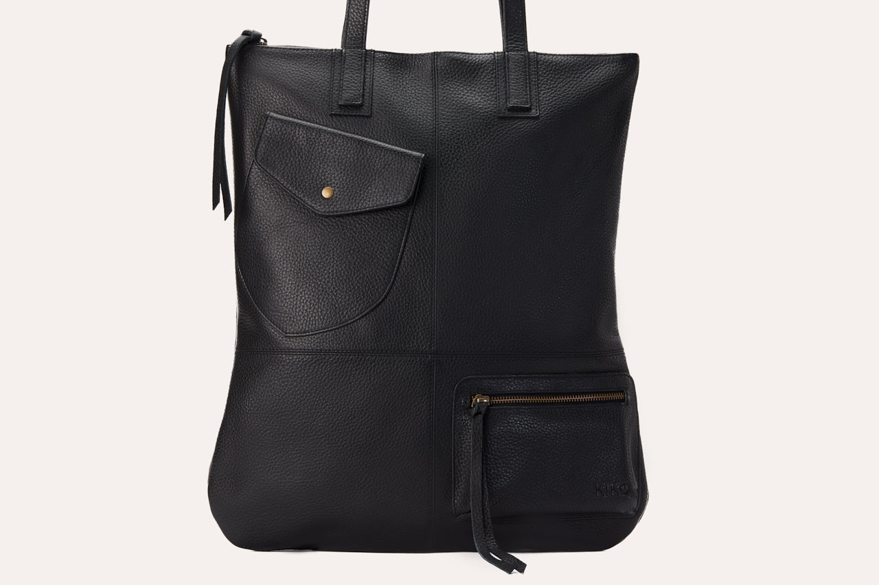 Fold n Hold Tote in cowhide leather with large interior and two exterior pockets, soft plaid lining, and zipper tassels