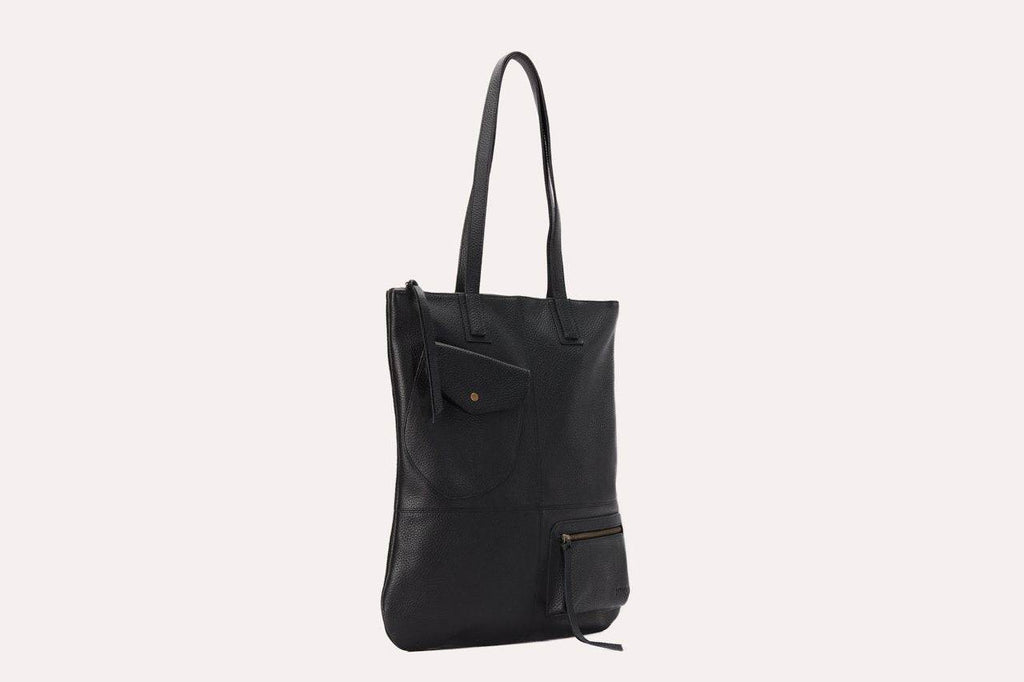 Fold n Hold Tote in cowhide leather with large interior and two exterior pockets, plaid lining, and zipper tassels