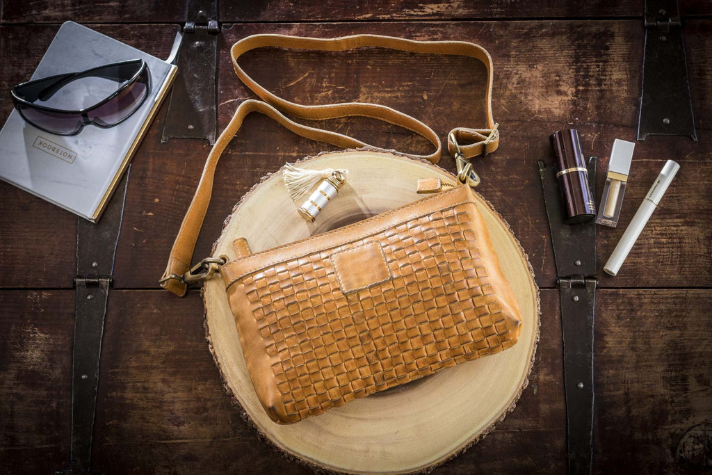 Kiko Weaved Crossbody Bag in genuine washed leather with adjustable strap and zip closure displayed on white background