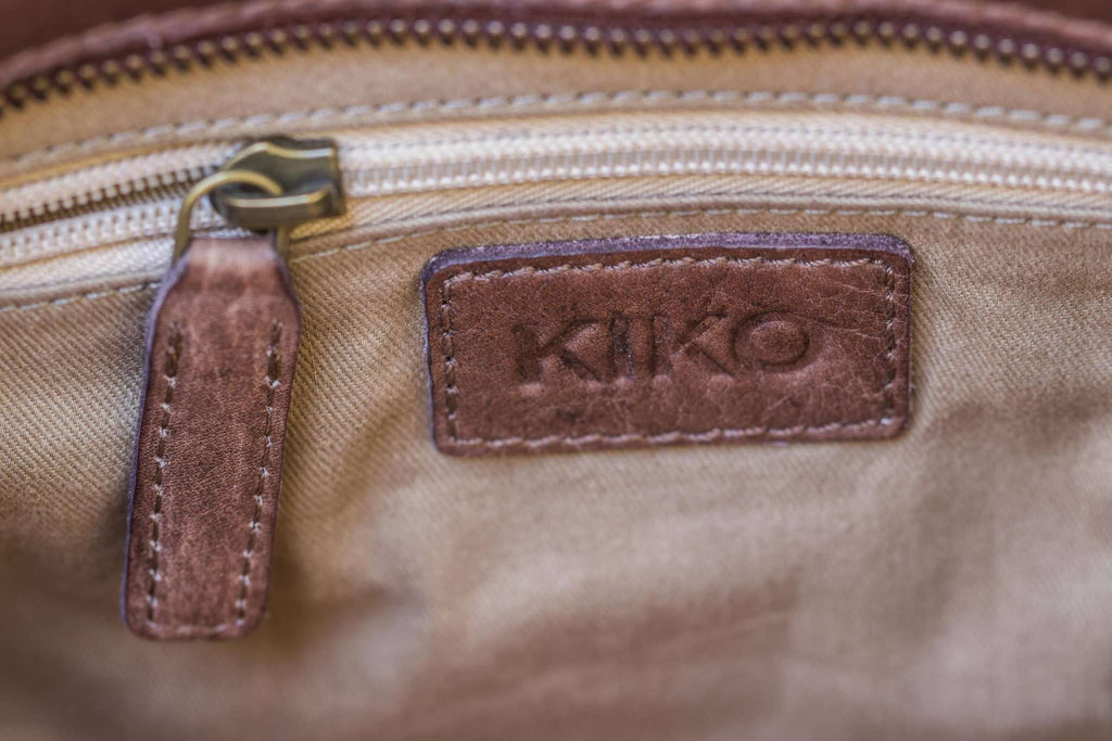 Kiko Weaved Crossbody Bag in genuine washed leather with adjustable strap and zip closure