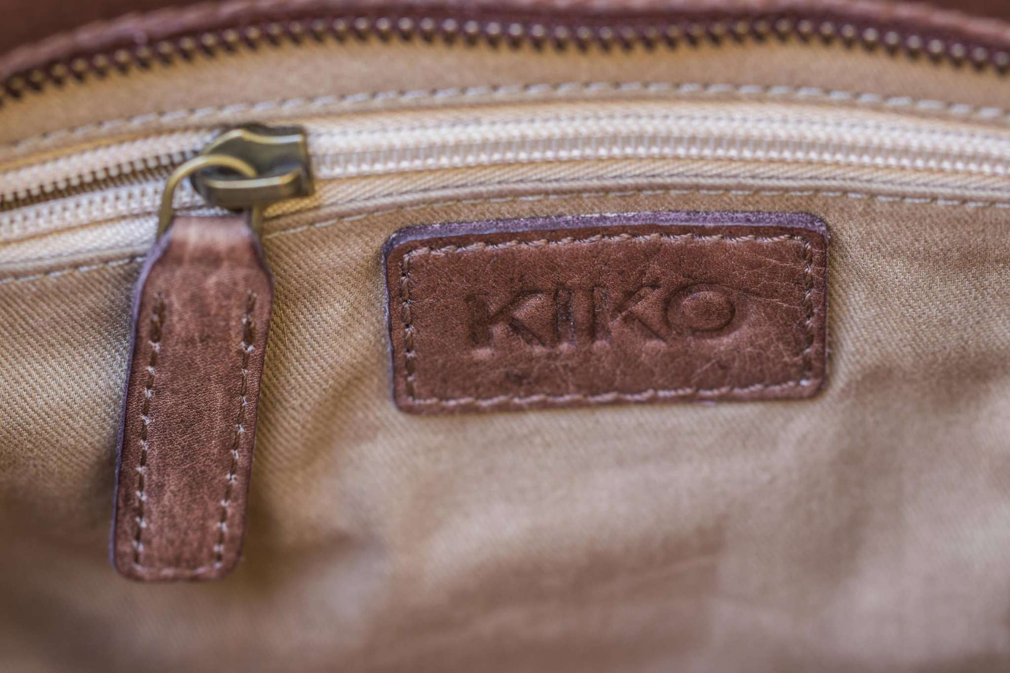 Kiko Weaved Crossbody Bag in genuine washed leather with adjustable strap and zip closure