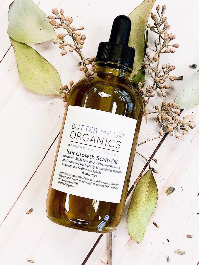 Bottle of organic scalp treatment oil by Butter Me Up Organics for hair growth with natural herbs and oils