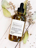 Bottle of organic scalp treatment oil by Butter Me Up Organics for hair growth with natural herbs and oils
