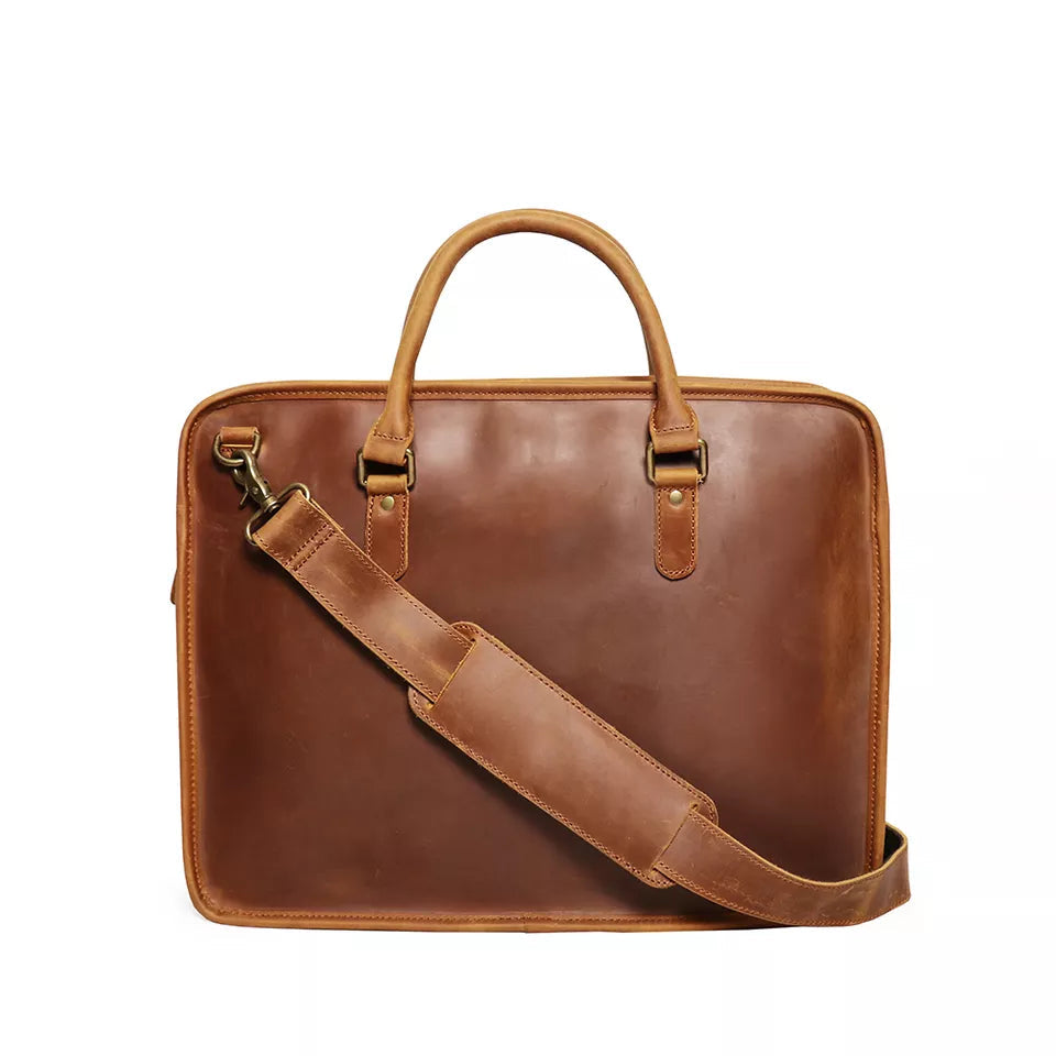 Hemming Leather Laptop Bag in rich brown leather, featuring dual top handles, a detachable shoulder strap and sleek briefcase design