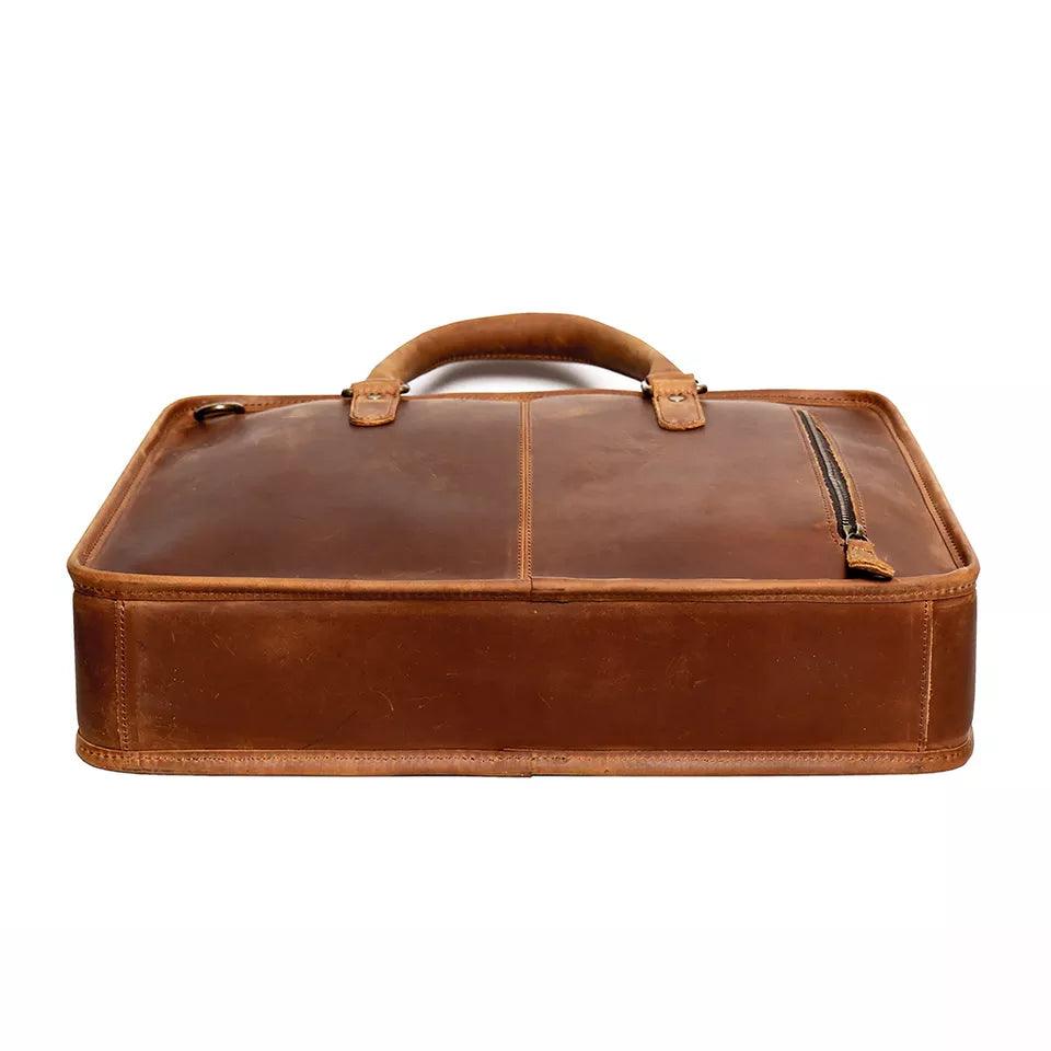 Hemming Leather Laptop Bag, a brown leather briefcase with a structured shape, top handle, and front zip pocket