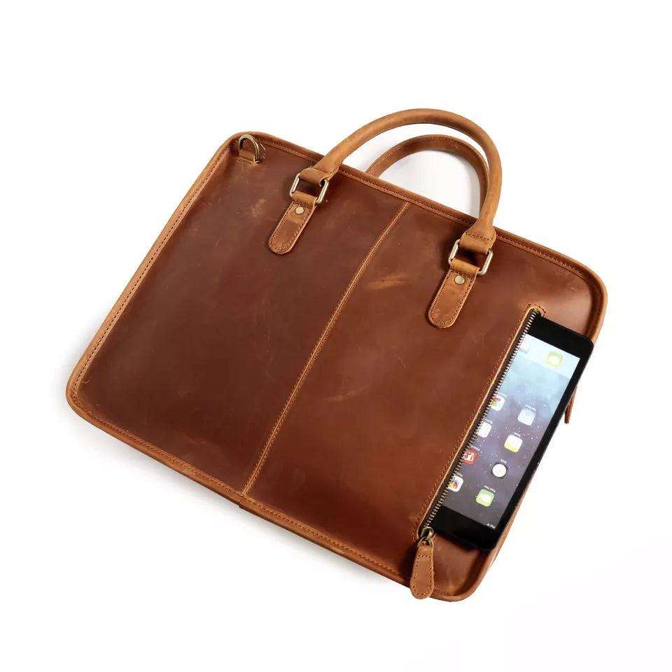 Hemming Leather Laptop Bag in brown Crazy Horse leather, featuring top handles and a front zippered compartment with tablet
