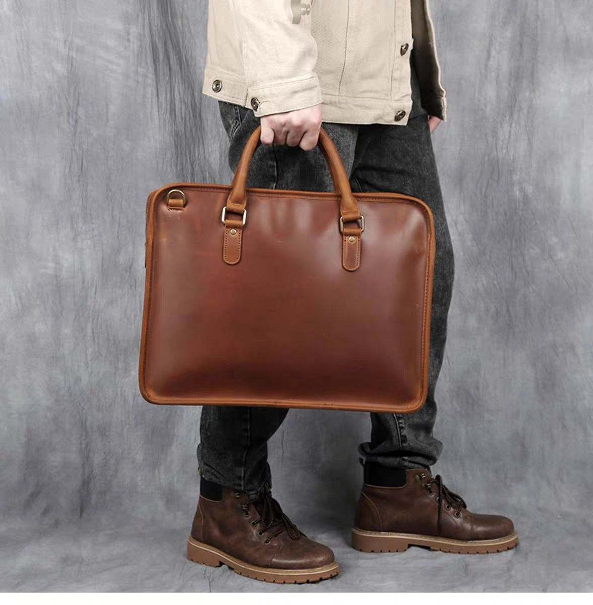 Hemming Leather Laptop Bag, a smooth brown leather briefcase with dual handles and rounded zippered edges