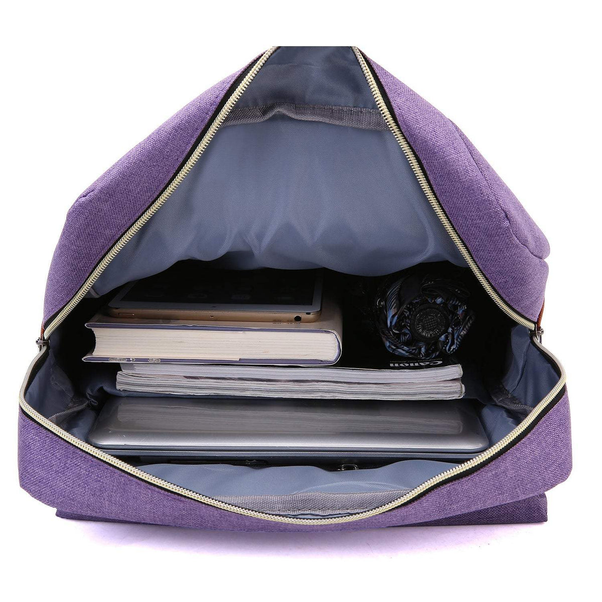Vintage Laptop Backpack in purple fabric, unzipped to show a roomy gray-lined interior with books and a laptop.