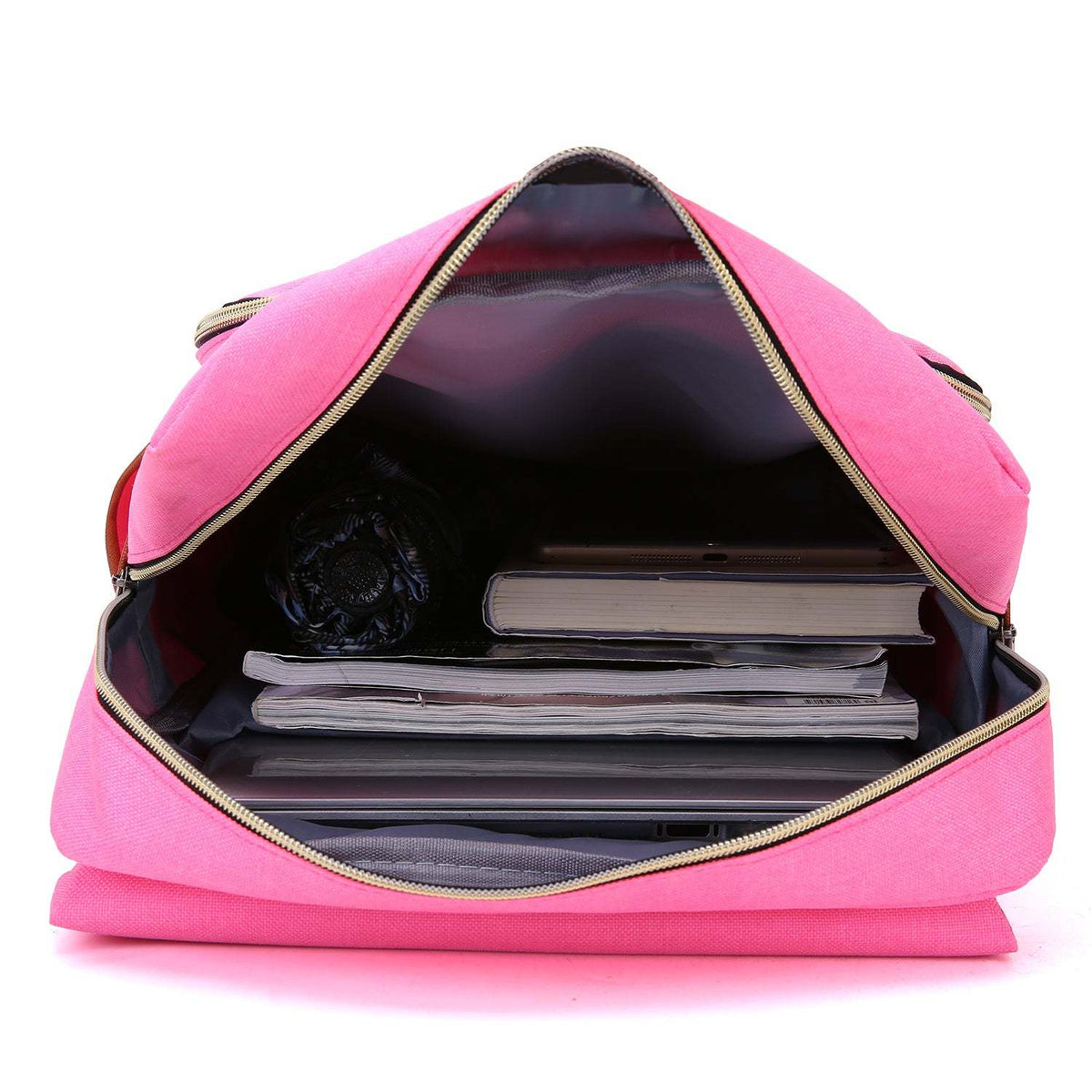 Zela Slim Backpack in bright pink fabric, open wide to reveal a dark lined interior with books and a laptop.
