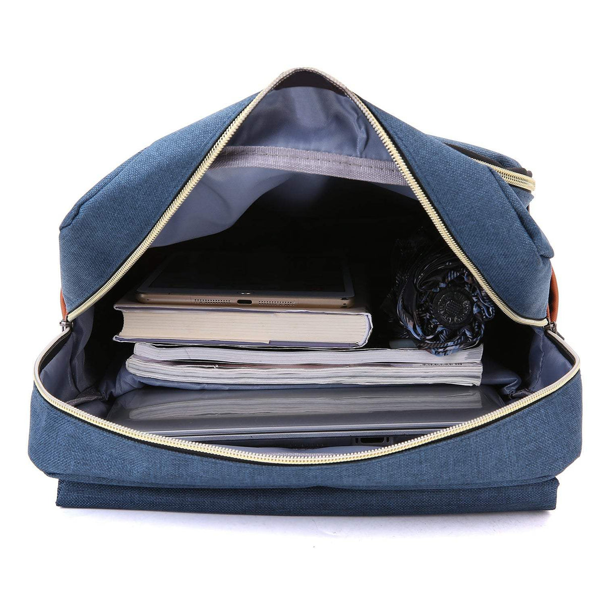 Slim Backpack in blue textured fabric, shown open with a spacious compartment holding a laptop, books and a rolled item.