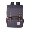 Vintage Laptop Backpack in charcoal gray woven fabric, with a flap, tan leather-like buckle straps, front zip pocket and side pockets.