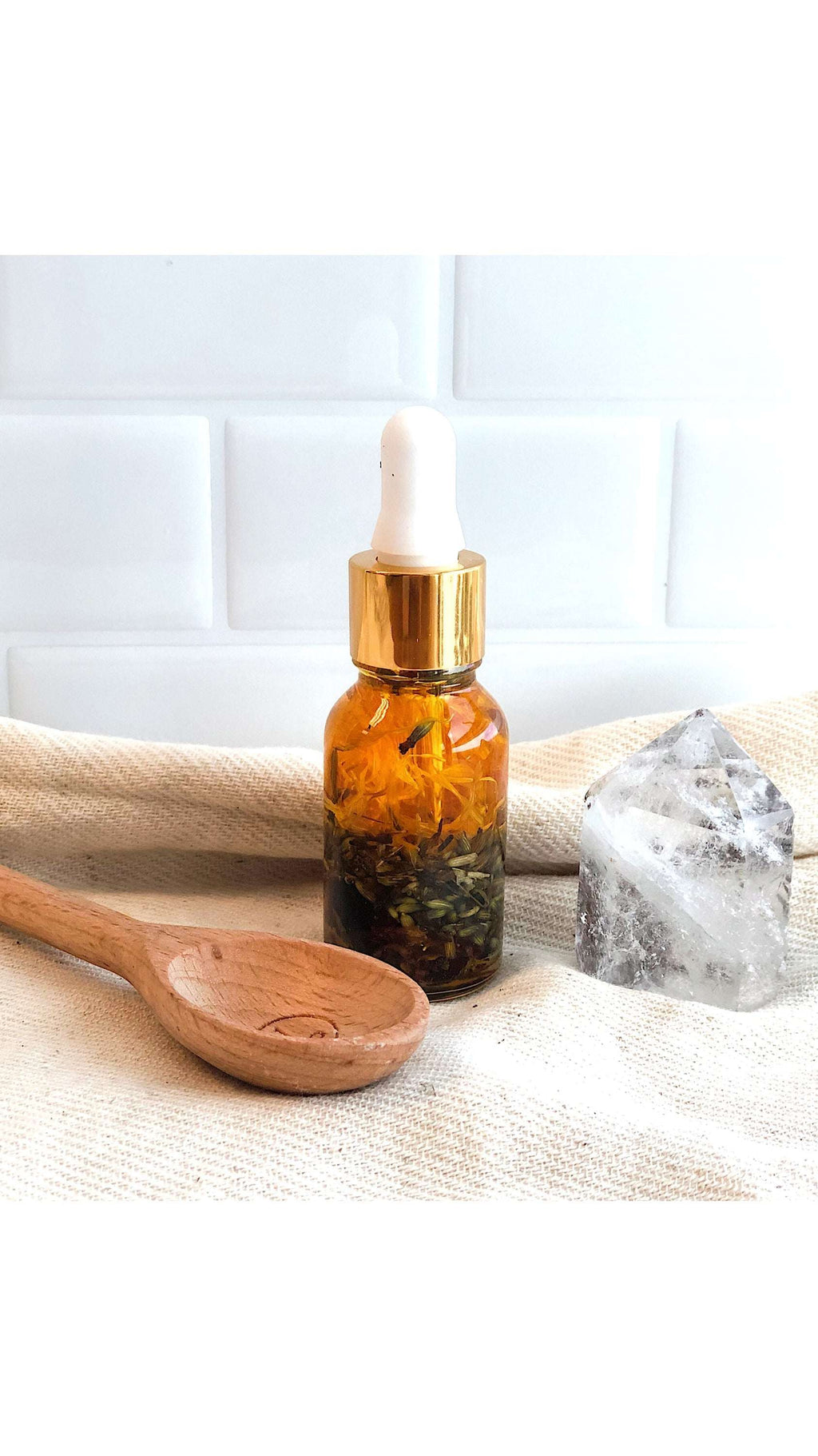 Luxurious healing face serum in elegant Italian glass bottle with yellow oils and herbs by Butter Me Up organic anti aging youth serum