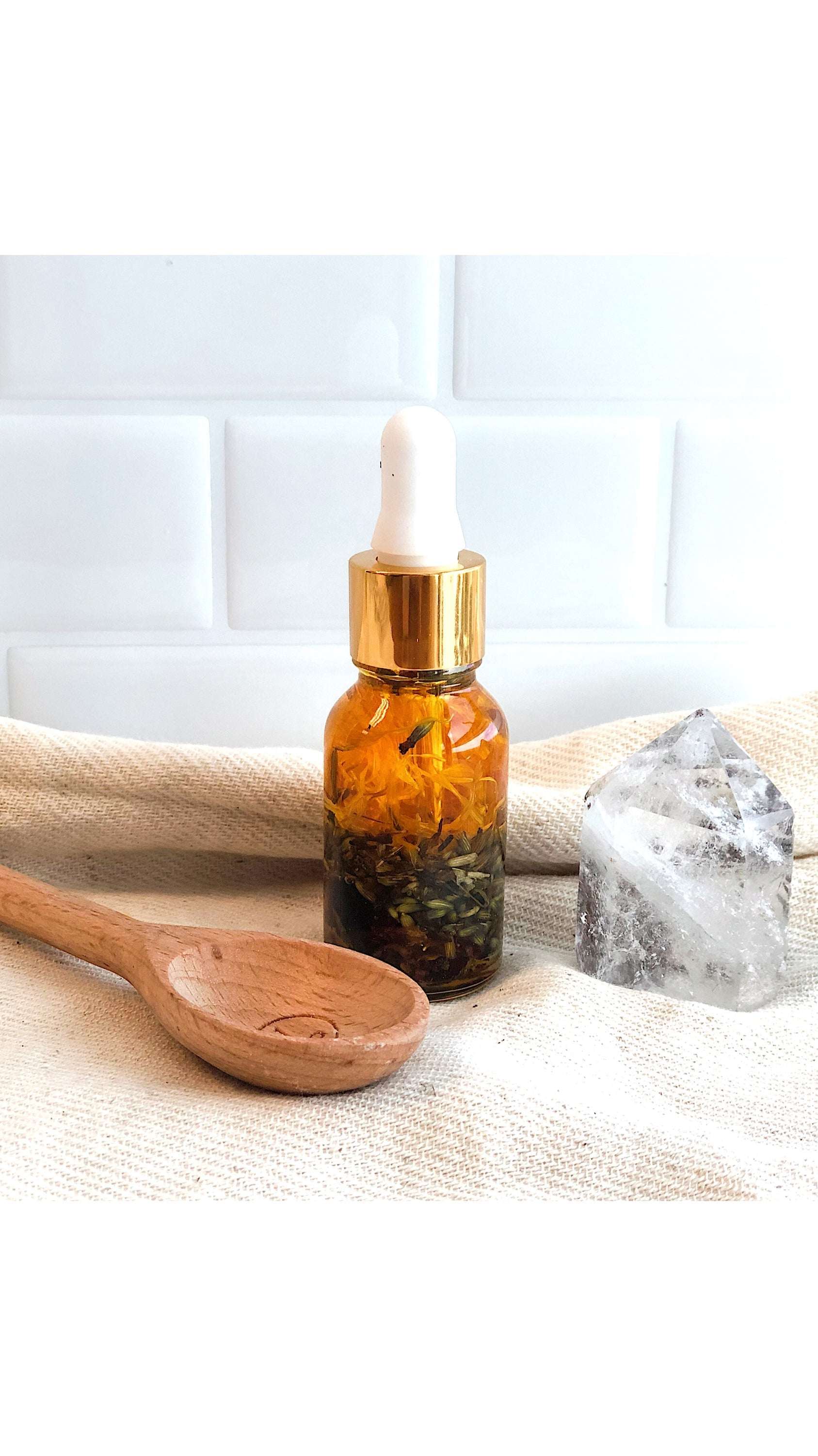 Luxurious healing face serum in elegant Italian glass bottle with yellow oils and herbs by Butter Me Up organic anti aging youth serum