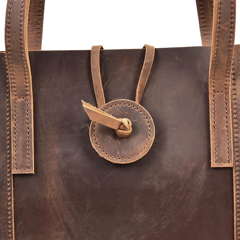Handcrafted leather tote bag in durable crazy horse leather with ergonomic straps and removable clutch