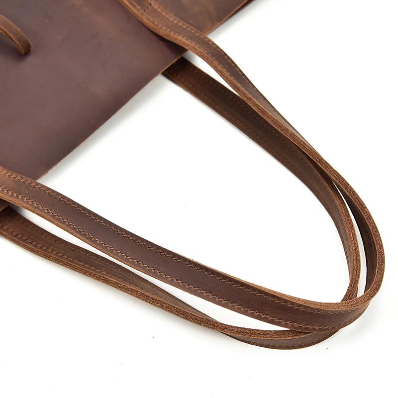 Handcrafted leather tote bag made of durable crazy horse leather with ergonomic straps and removable clutch