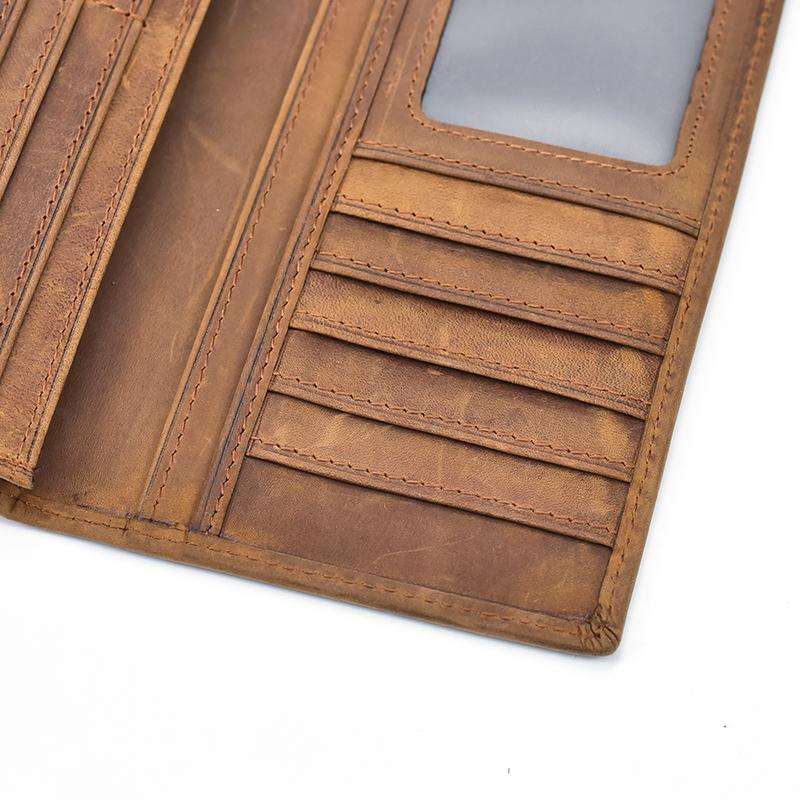 The Pathfinder Bifold Wallet made of genuine Crazy Horse leather with multiple card slots, a clear ID window, zippered coin pocket, and slim design