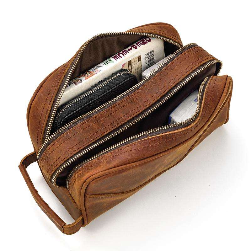 Genuine leather travel toiletry bag in brown with multiple pockets for organized travel essentials