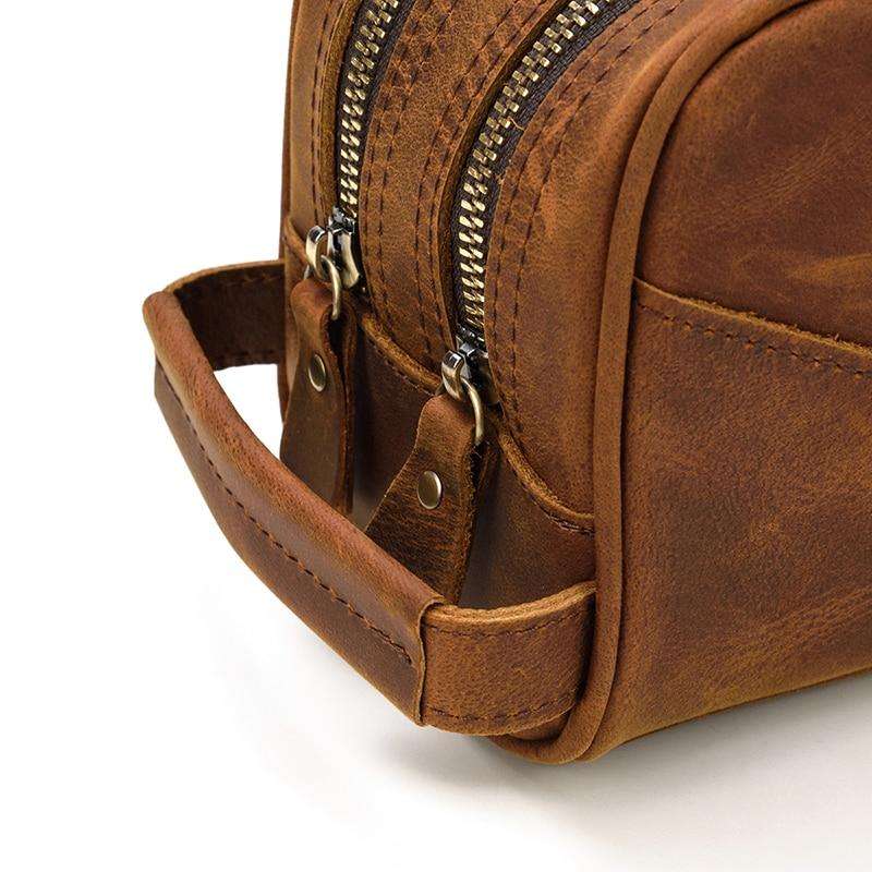Genuine leather travel toiletry bag in brown with multiple compartments for organized packing