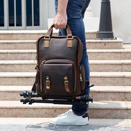 Large leather camera bag backpack made of full-grain crazy horse leather with padded straps and multiple compartments for photography gear and laptop