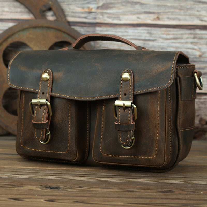 The Faust Leather Crossbody Messenger Bag made of full-grain crazy horse leather with adjustable shoulder strap and camera compartments