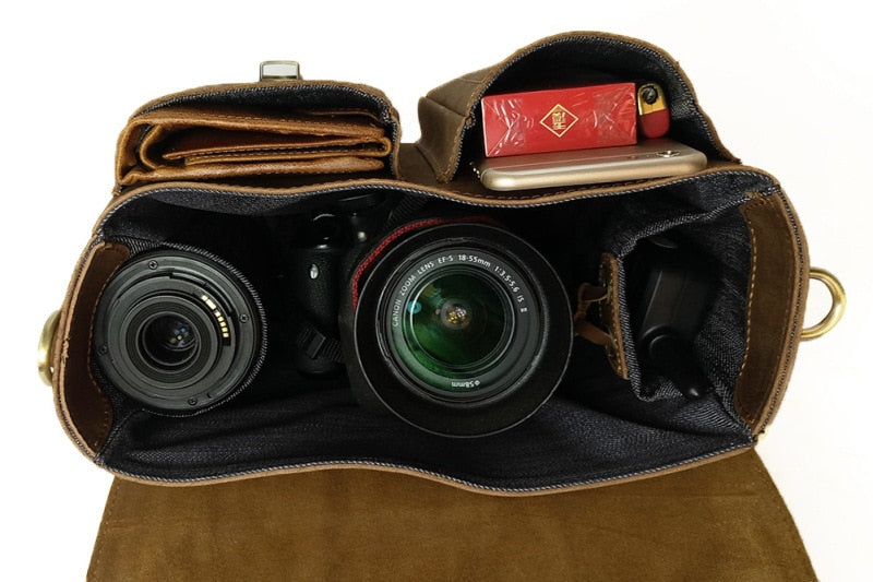 The Faust Leather Crossbody Messenger Bag made of full-grain crazy horse leather with adjustable strap and compartments for camera gear.