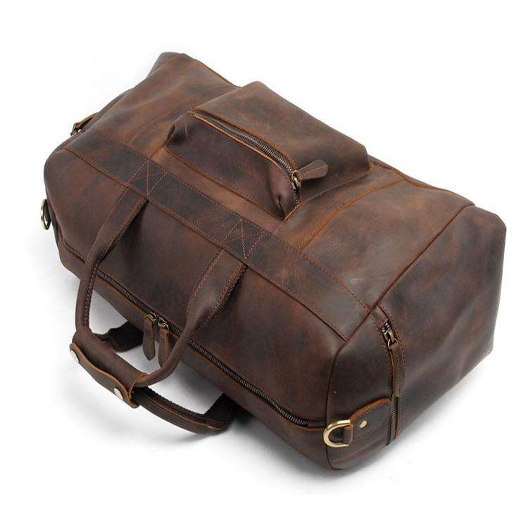 Handcrafted leather duffle bag in vintage style with spacious compartments and adjustable strap