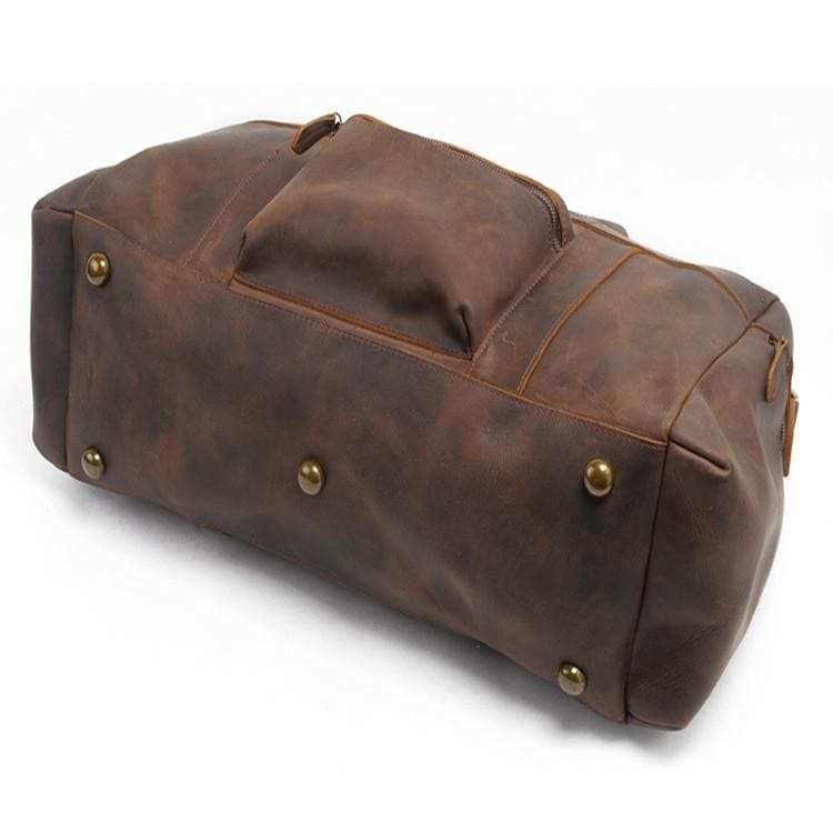 Handcrafted leather duffle bag in rich brown vintage style with sturdy handles and adjustable shoulder strap