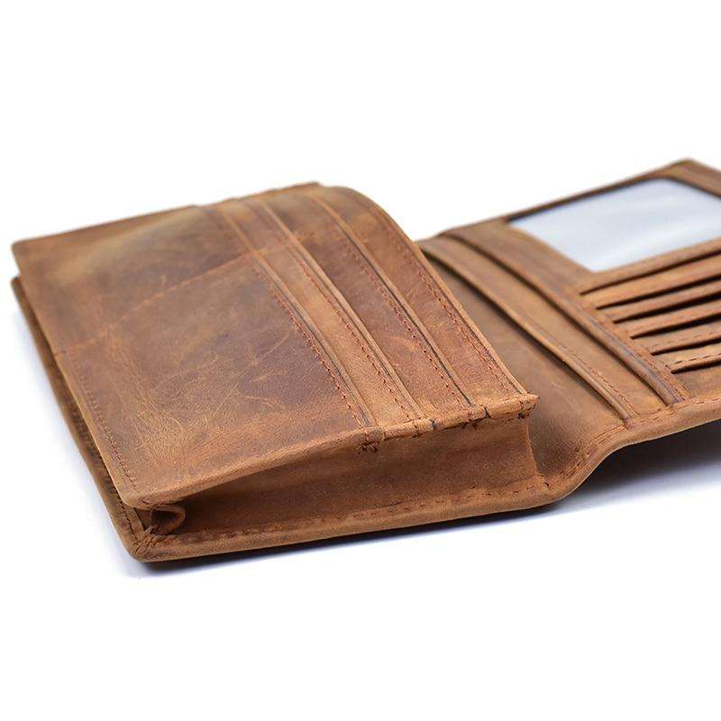 The Pathfinder Bifold Wallet in genuine Crazy Horse leather with multiple card slots, clear ID window, zippered coin pocket, and slim design