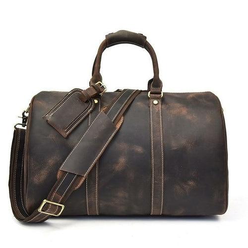The Brandt Weekender small black leather duffle bag with adjustable shoulder strap and top handle