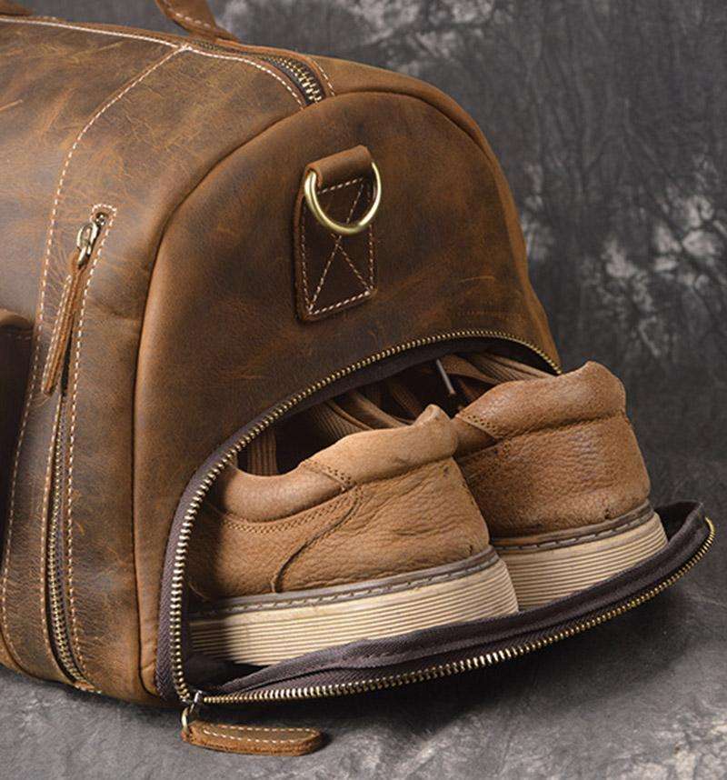 Handmade leather duffle bag in rich brown crazy horse leather with top handles and shoulder strap for travel