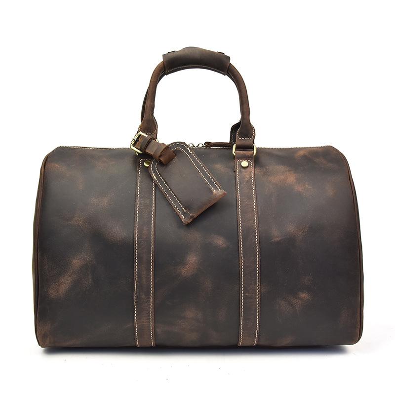 The Brandt Weekender small black leather duffle bag with adjustable strap and multiple compartments