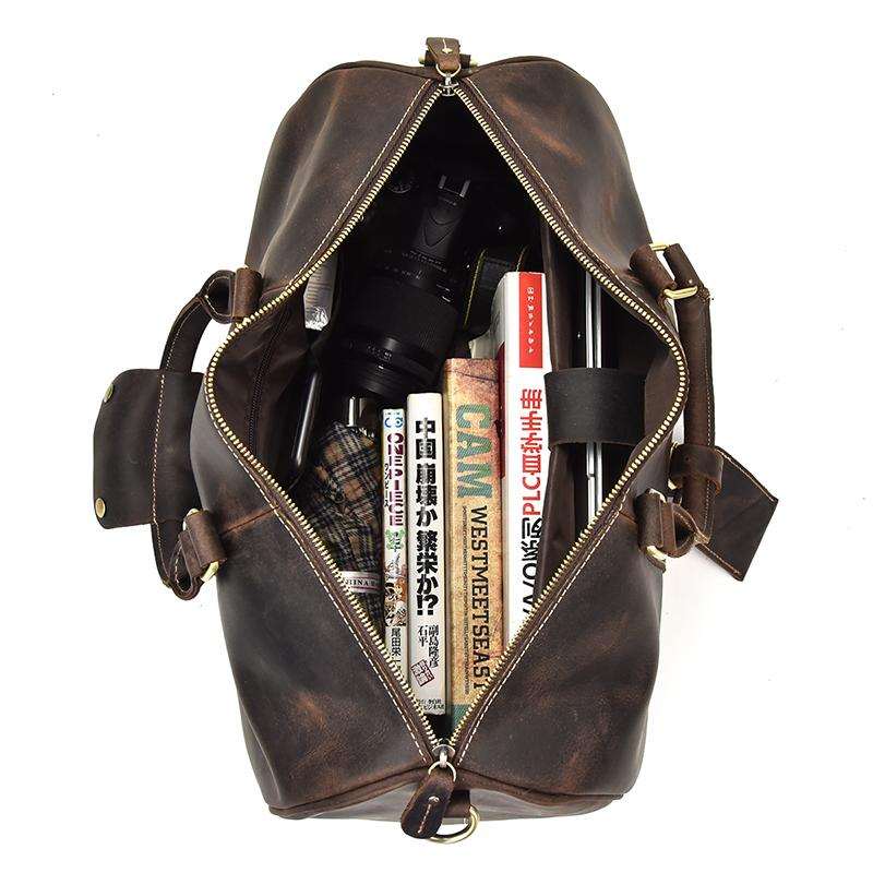The Brandt Weekender small black leather duffle bag with adjustable shoulder strap and top handle for travel and work