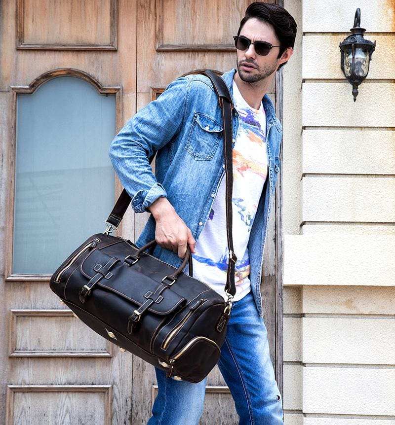Handmade leather duffle bag in rich brown crazy horse leather with soft handles and removable shoulder strap, designed for travel and spacious storage