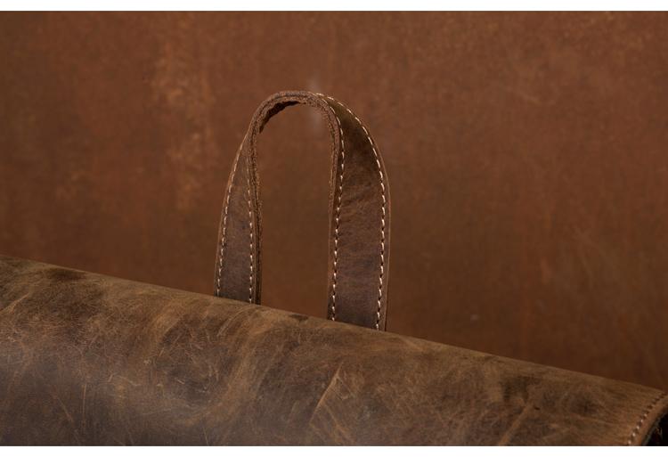 Vintage Leather Backpack in rugged brown leather, featuring a stitched padded top grab handle and distressed finish